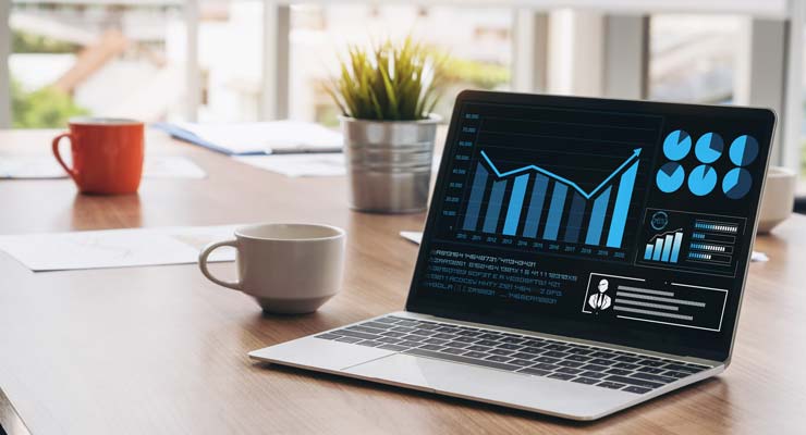 Improve Your Supply Chain With an Effective Data Strategy laptop showing analytics on conference table