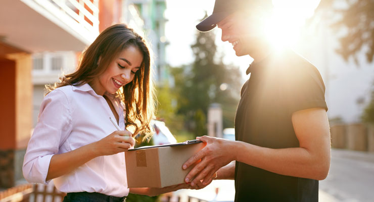 How Retailers Can Maximize Delivery Performance woman signing for package